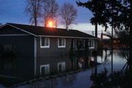 Arctic air sweeps south as residents of the Pacific Northwest remain on guard after severe flooding