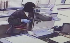 Officials looking for a man accused of robbing Midlands post office at gun point