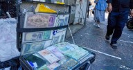 Iran's currency falls to a new low as nuclear sanctions squeeze its ailing economy