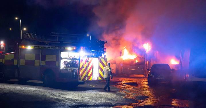 Firefighters tackle huge blaze at bus depot in Scots town as cops lock down area