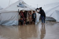 Desperate children in Gaza try to keep floodwater out of tents