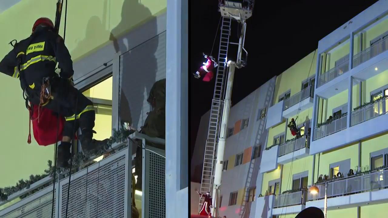 Greek firefighters rappel down hospital building as Santas to deliver gifts to sick children