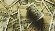 Rupee slides to record low of Rs 90.25 amid FII outflows and rising dollar demand