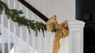 Easily Hang Your Garland From A Banister With This Simple Trick