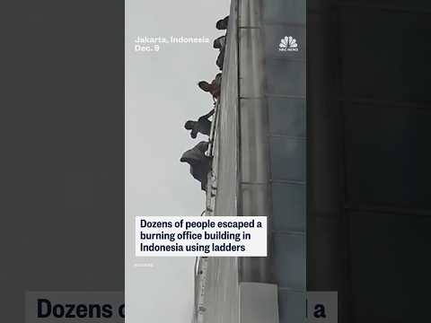Dozens of people escaped a burning office building in Indonesia using ladders