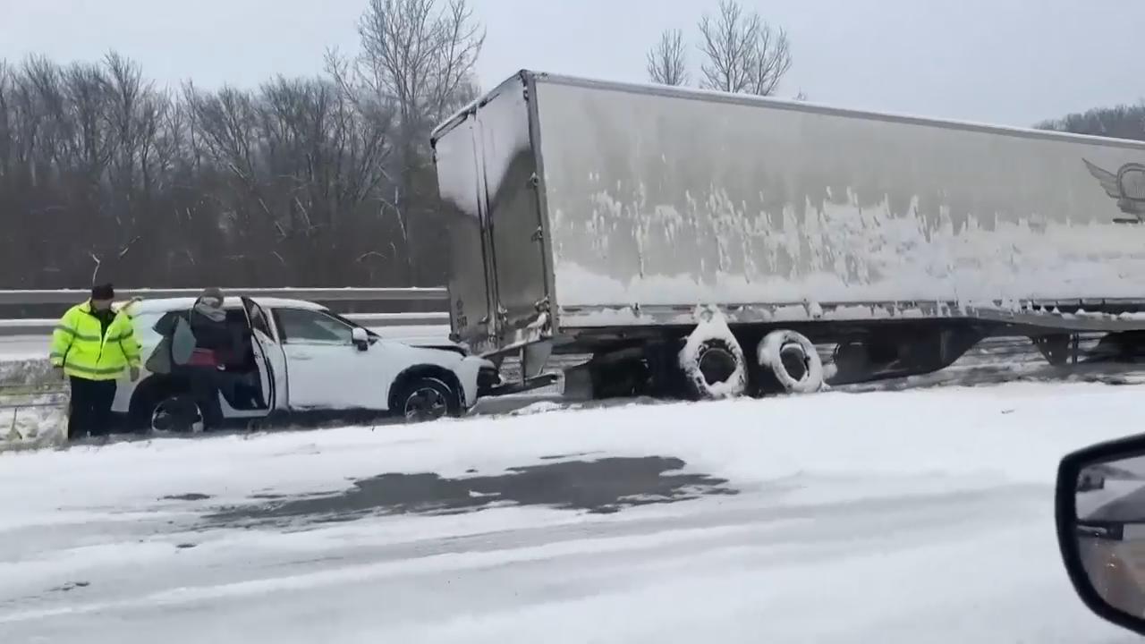Cars and trucks stuck on snow-covered Interstate 70 as wintry weather moves through Missouri
