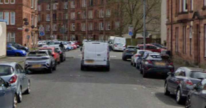 Glasgow road shut after crash involving pedestrian and motorbike