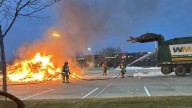 Omaha sanitation worker quickly dumps garbage in parking lot after it catches on fire