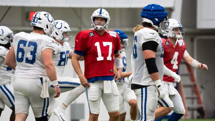 Philip Rivers pulls cleats from a trophy case to use with Indianapolis Colts
