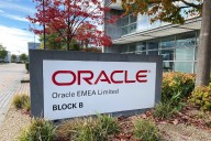 Oracle misses sales and operating profit estimates as shares decline, indicating drop in corporate spending