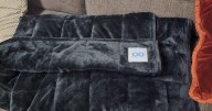 'Oodie's weighted blanket kept me warm during a cold spell and has one perk for sleeping'
