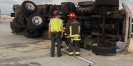 Garbage truck rolls over on Bayside Bridge