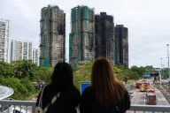 Hong Kong fire probe reveals unsafe netting as public mourns and government stifles dissent