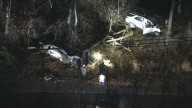 Crash leads 2 cars into wooded area off road in NJ