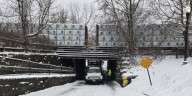 Truck stuck under railroad bridge causes road closure