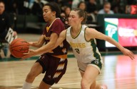Photos of Birmingham Groves and Farmington Hills Mercy in a D1 girls hoops contest