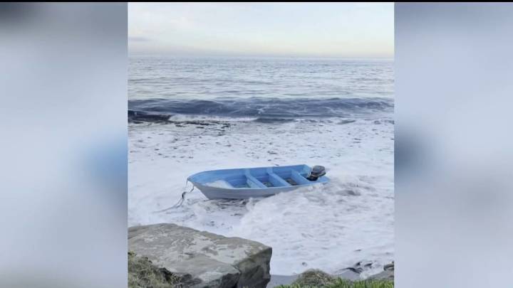 Empty panga boat washes along La Jolla shoreline