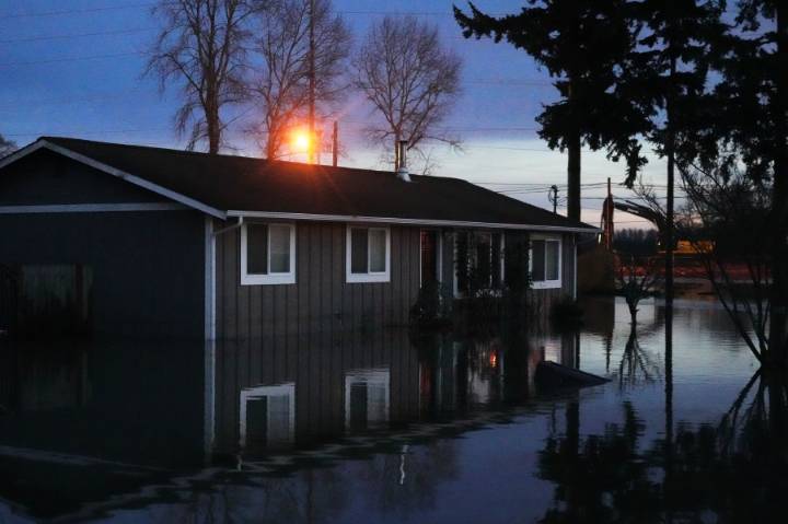 Arctic air sweeps south as residents of the Pacific Northwest remain on guard after severe flooding