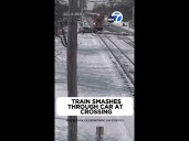 Train smashes through car at crossing