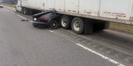 No injuries reported after car hits semi on I