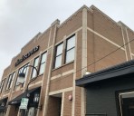 Panel supports sign for downtown Naperville Charles Schwab branch