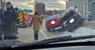FBI agent rescued after car left resting on top of retaining wall on I