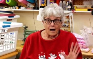 A Secret Santa surprises a single mom at a craft store and pays off her mortgage