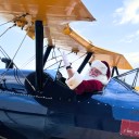 Stearman Santa – Santa arrives in a World War II open cockpit Stearman biplane. 10 am to 1 pm