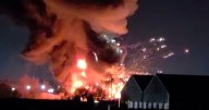 Dramatic moment explosion at unit 'full of fireworks' that forces a firefighter to flee