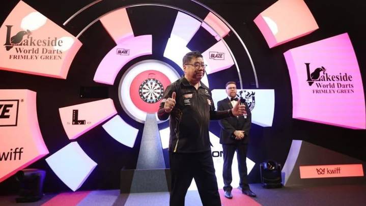 Singapore's Paul Lim, 71, becomes oldest winner of match at World Darts Championship