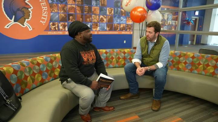 Purple Heart recipient who overcame trauma to write 2 books graduates with master's degree