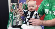 One of Newcastle's youngest fans poses with Carabao Cup in North Shields