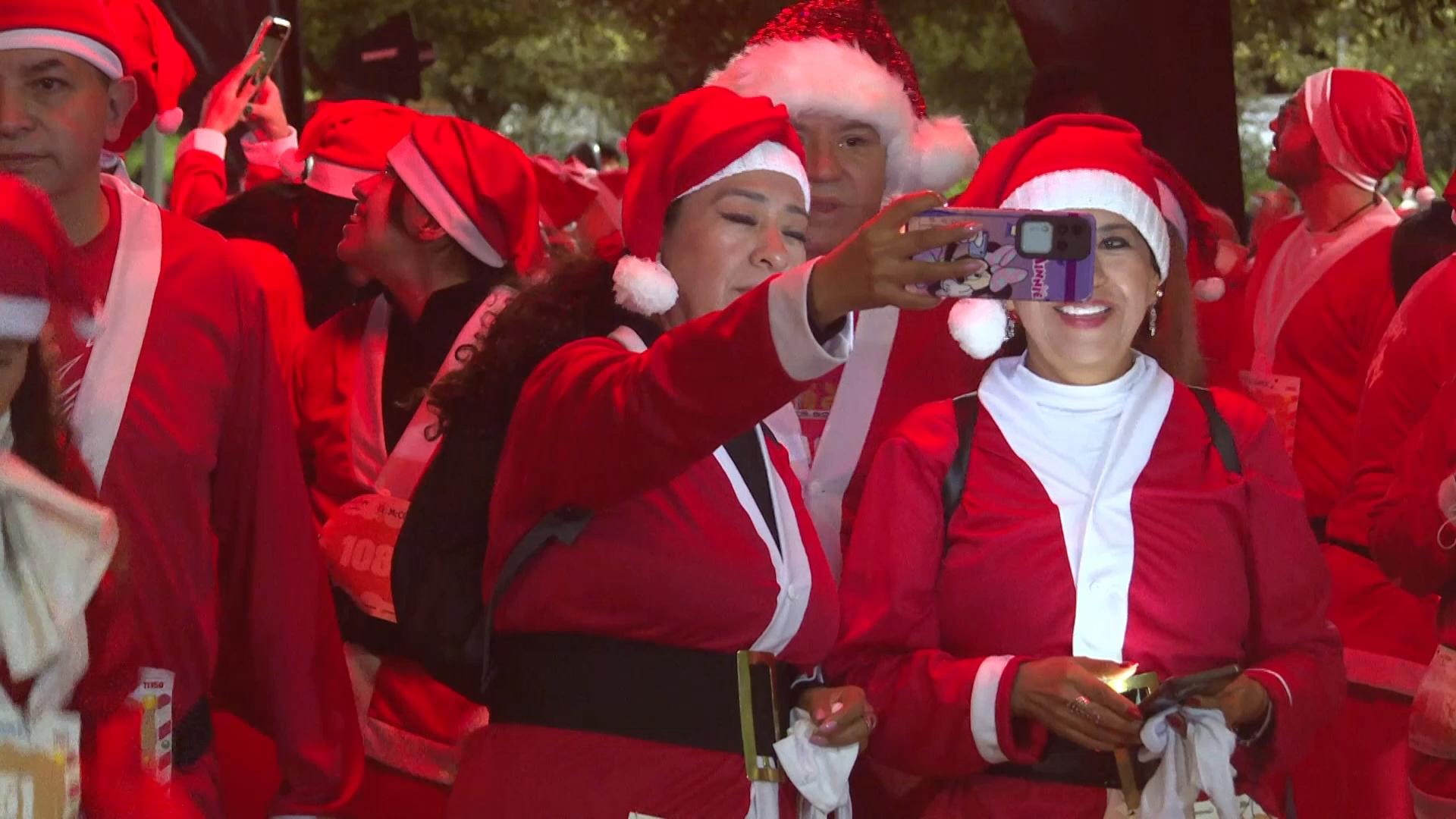 Jolly runners sprint in Santa outfits in Mexico City's Santa Run