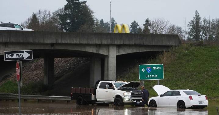Tens of thousands ordered to flee flooding after torrential rain in Pacific Northwest