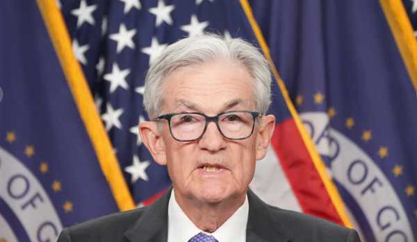 Fed lowers interest rate, sees stronger economy next year
