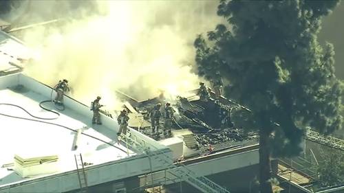 Students evacuated as firefighters battle rooftop fire on school campus in Granada Hills
