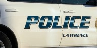 Lawrence police: Driver crashes into home then runs, leaving injured passenger behind