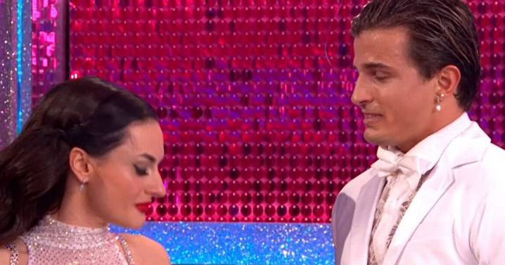 Strictly's Nikita Kuzmin halts live show to condemn 'hate' against Amber Davies