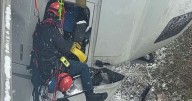 Firefighter rappels from bridge to save truck driver 