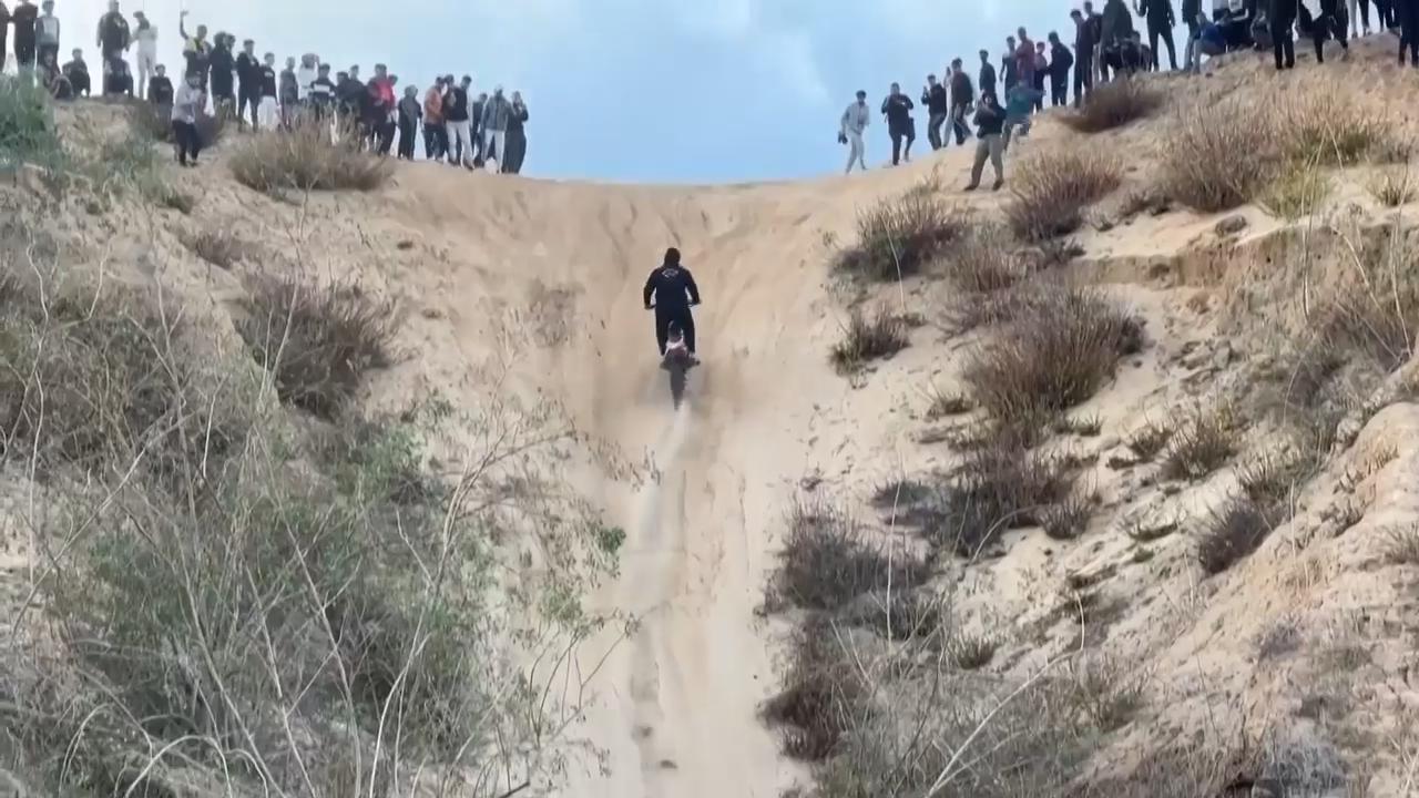 Motorcyclists roar over Gaza sand dunes in a return to pre