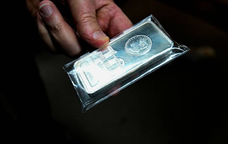 Gold holds steady, silver scales record high