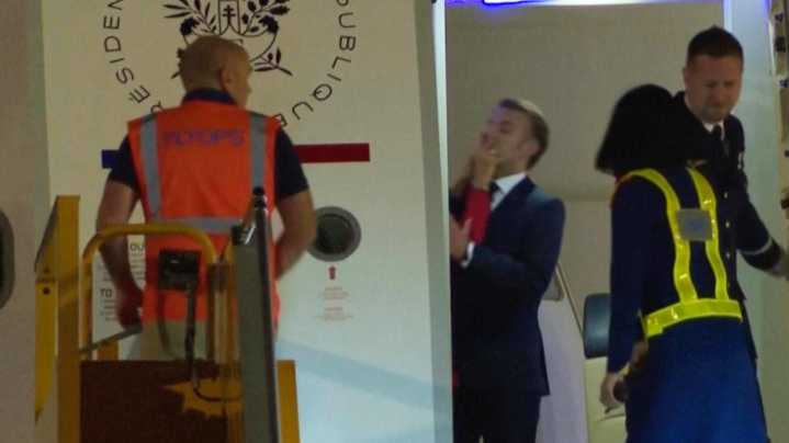 France's first lady seems to push her husband as they land in Vietnam. He says they were joking