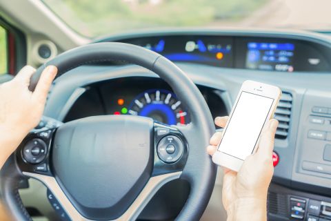Michigan House OKs ban on holding phones; violators face fines of $100 and up