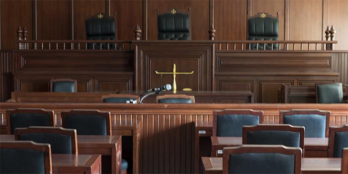 Former state trooper sues for her job back