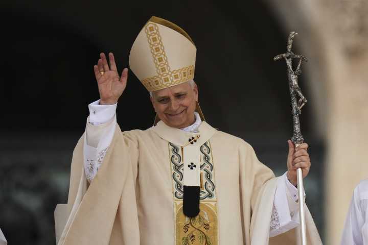 Pope Leo XIV offers message of unity for polarized Catholic Church as pontificate officially starts