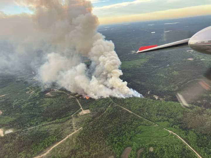 Crews fight heavy winds as fire nears community in northeastern B.C.
