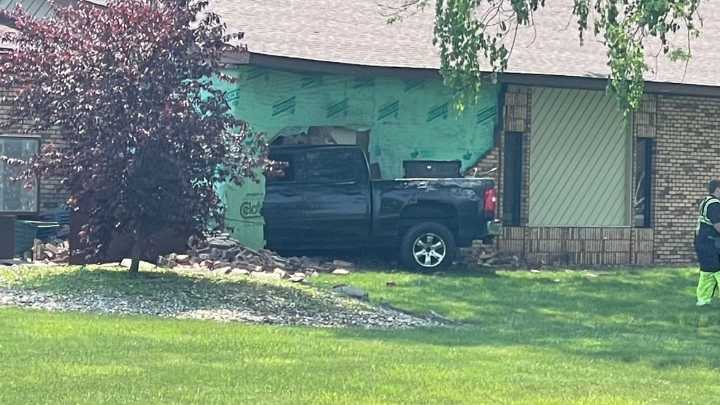 Truck crashes into building in Flint Township