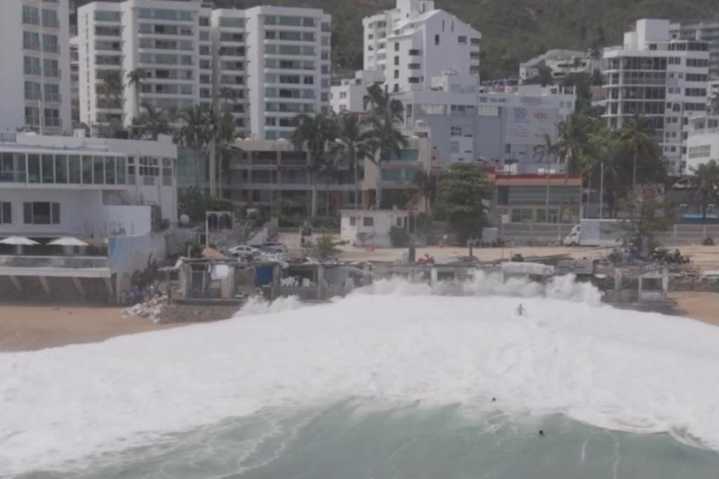 Drone video captures moment giant wave swallows up swimmers on Mexican beach