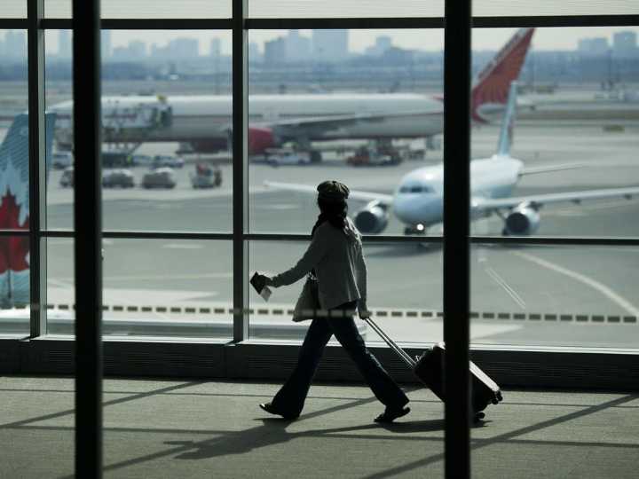 How many travellers flew from Canada to the United States in April?