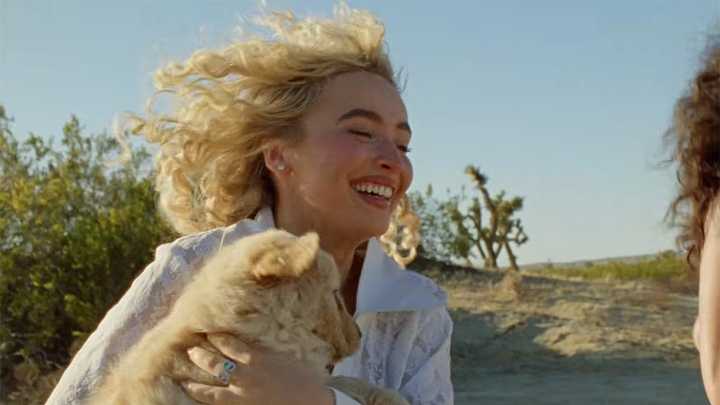 Sabrina Carpenter Brought Back The Pants-Free Look With Her Natural Curls And A Pupper In Tow